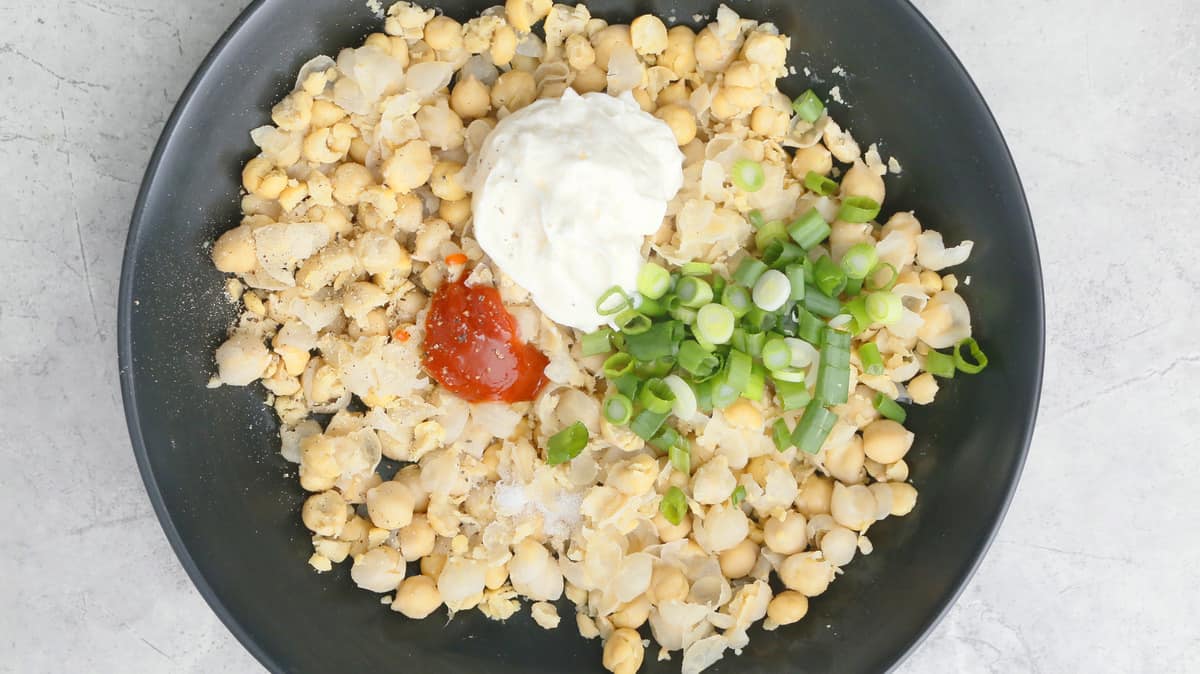 chickpeas, mayo, sriracha and scallion in a bowl
