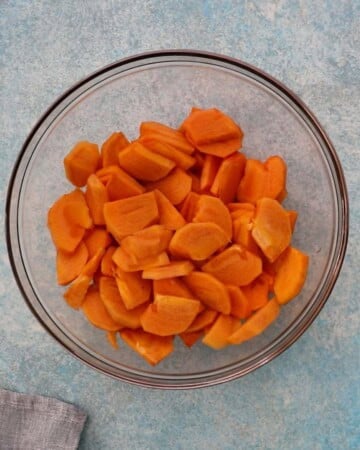 sliced persimmons in a glass bowl.