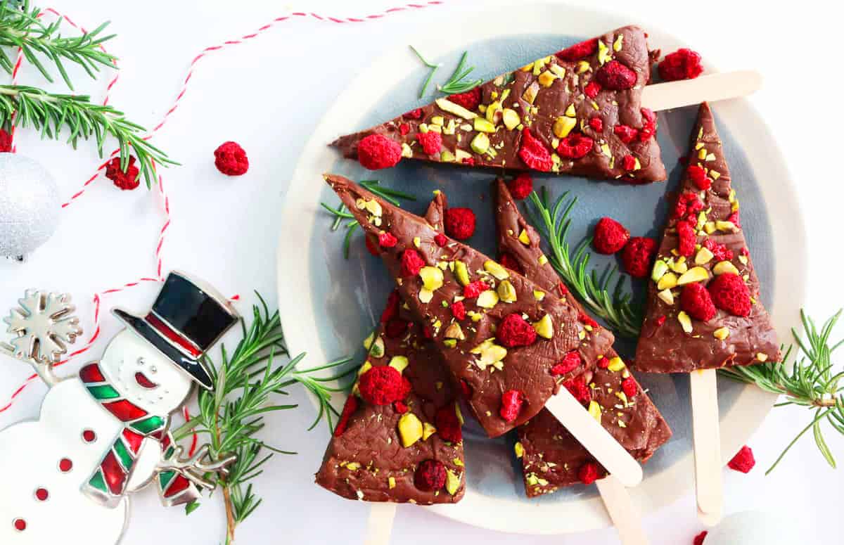 Christmas fudge wedges placed on a round grey plate.