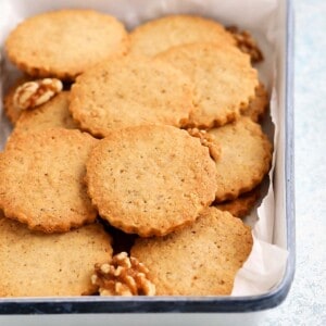 round shaped walnut cookies placed on a white tray.