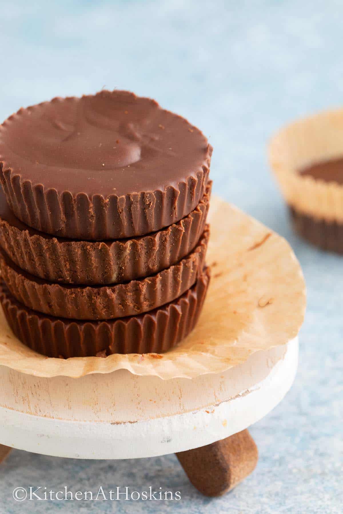 4 stacked chocolate cups on a small cake stand. 
