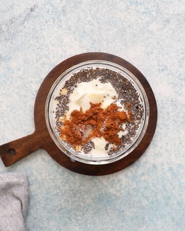 a glass jar filled with all ingredients needed to make banana overnight oats.