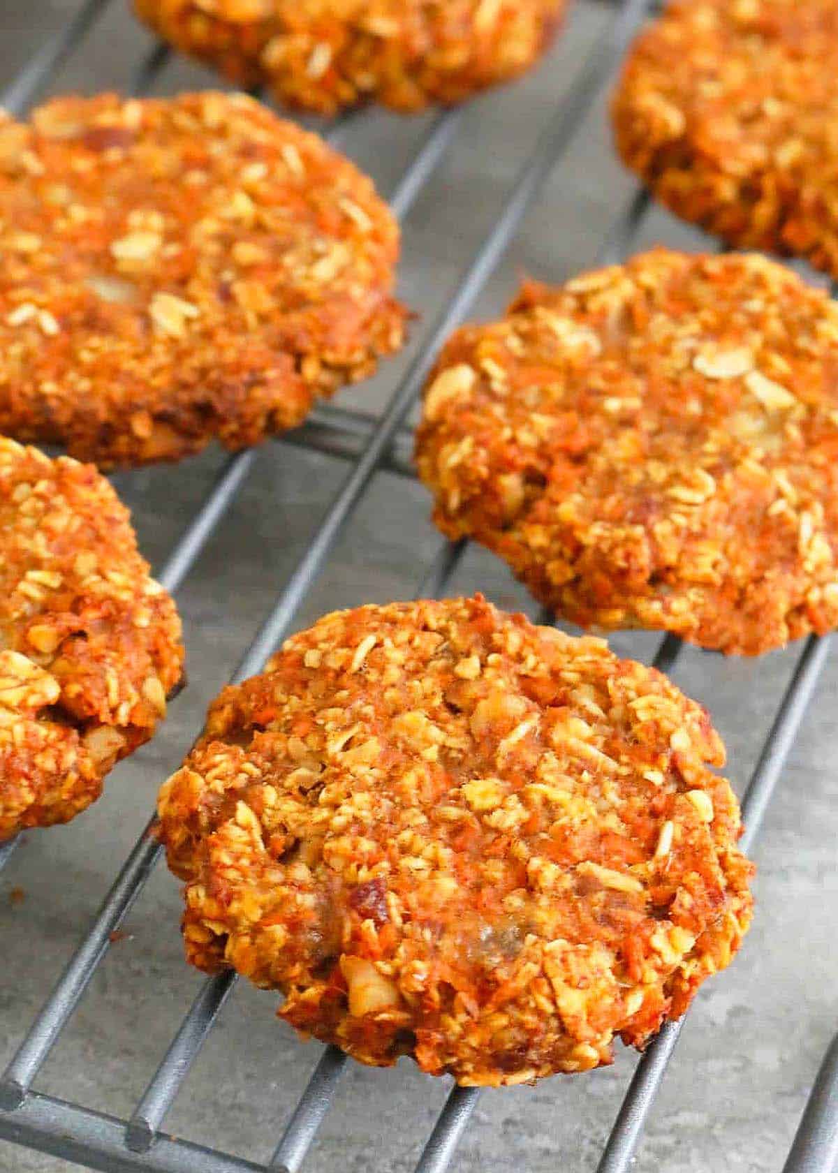 orange colored carrot cookies placed on a wire rack.