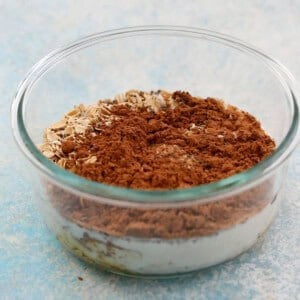 cocoa powder and oats in a glass bowl.