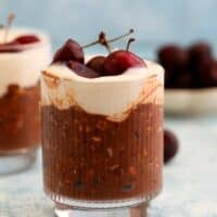 two glass jars with chocolate cherry overnight oats.
