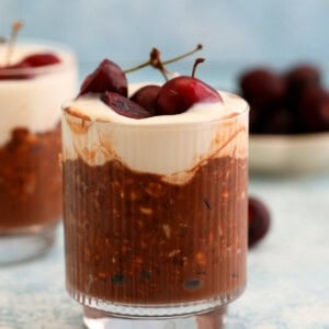 two glass jars with chocolate cherry overnight oats.