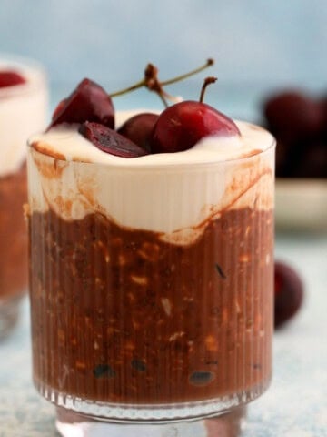 two glass jars with chocolate cherry overnight oats.