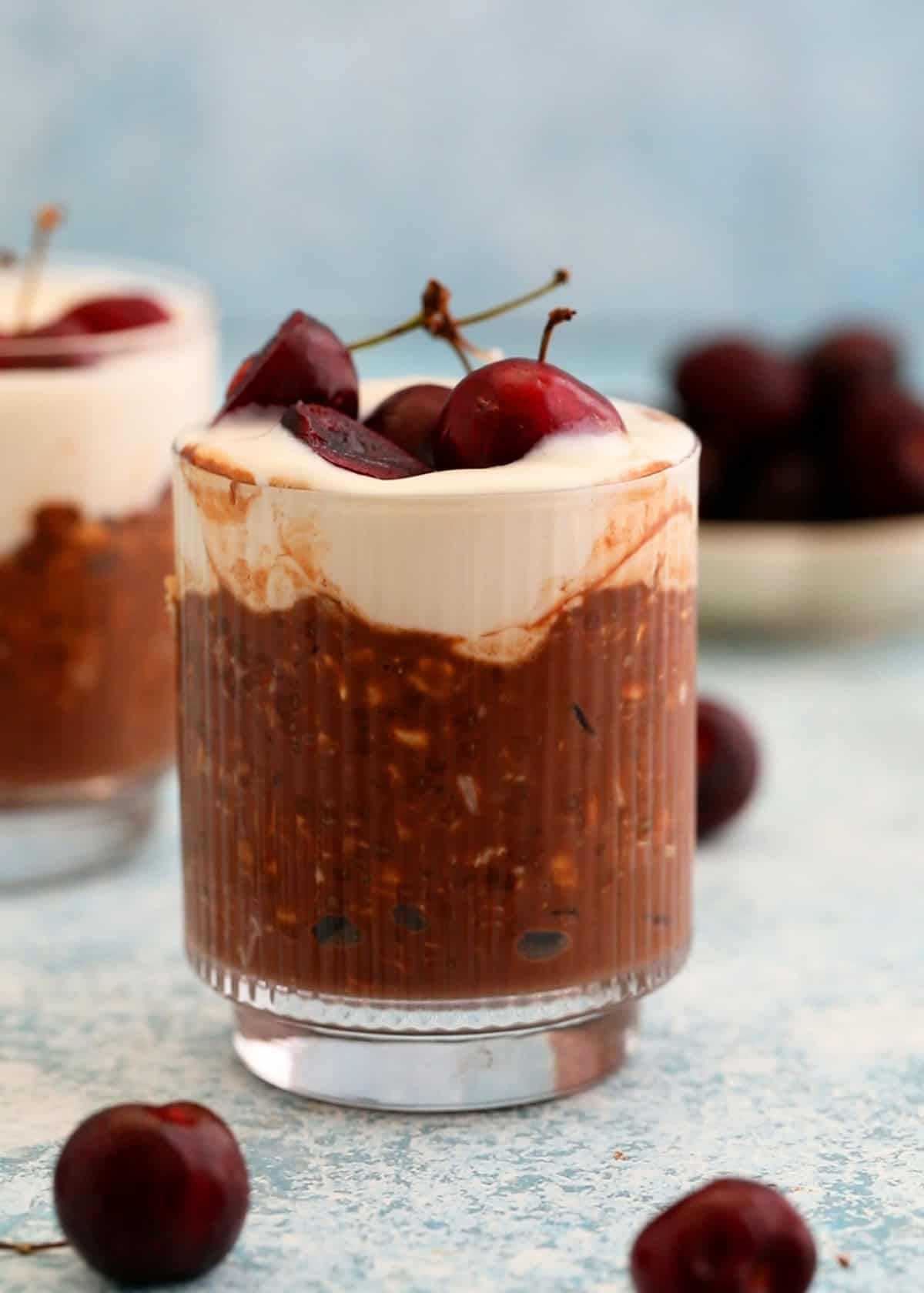 two glass jars with chocolate cherry overnight oats.