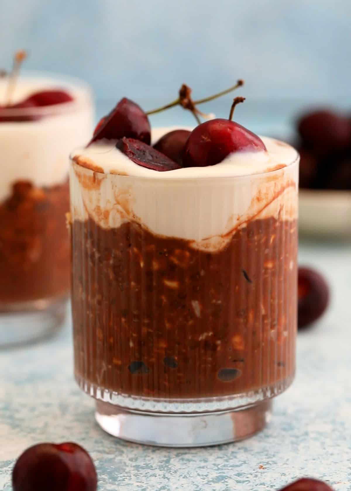 two glass jars with chocolate cherry overnight oats.