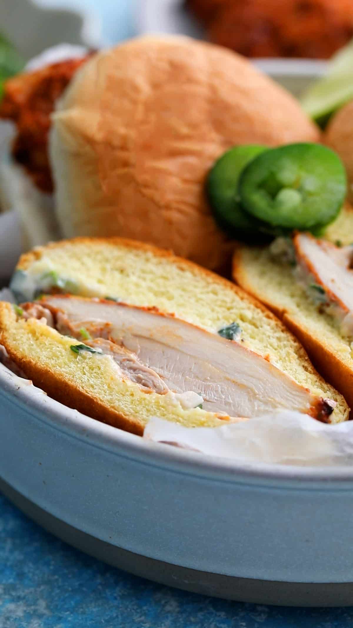 three spicy chicken sandwiches in a white bowl.