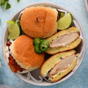 three spicy chicken sandwiches in a white bowl.