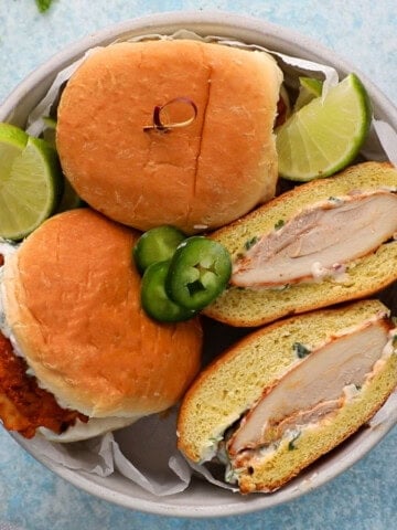 three spicy chicken sandwiches in a white bowl.