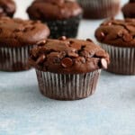 4 chocolate muffins placed on a blue board.