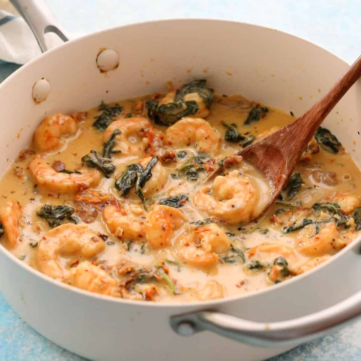 creamy Tuscan shrimp in a white pan.
