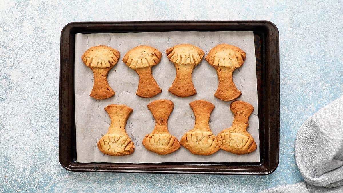 tree shaped cookies placed in a baking sheet.