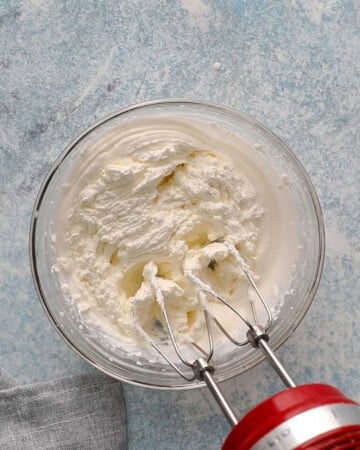whipped white whipped cream in a glass bowl. 