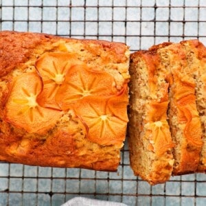 sliced persimmon bread placed on a wire rack.