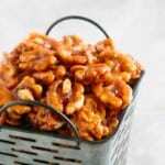candied walnuts piled high in a grey metal basket.