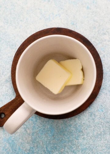 two slices of white butter in a white mug.