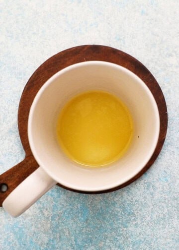 melted butter in a white mug.