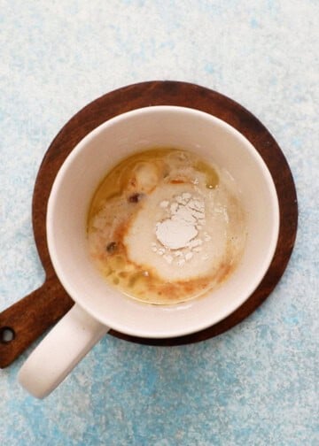 white flour and baking powder in a white mug.