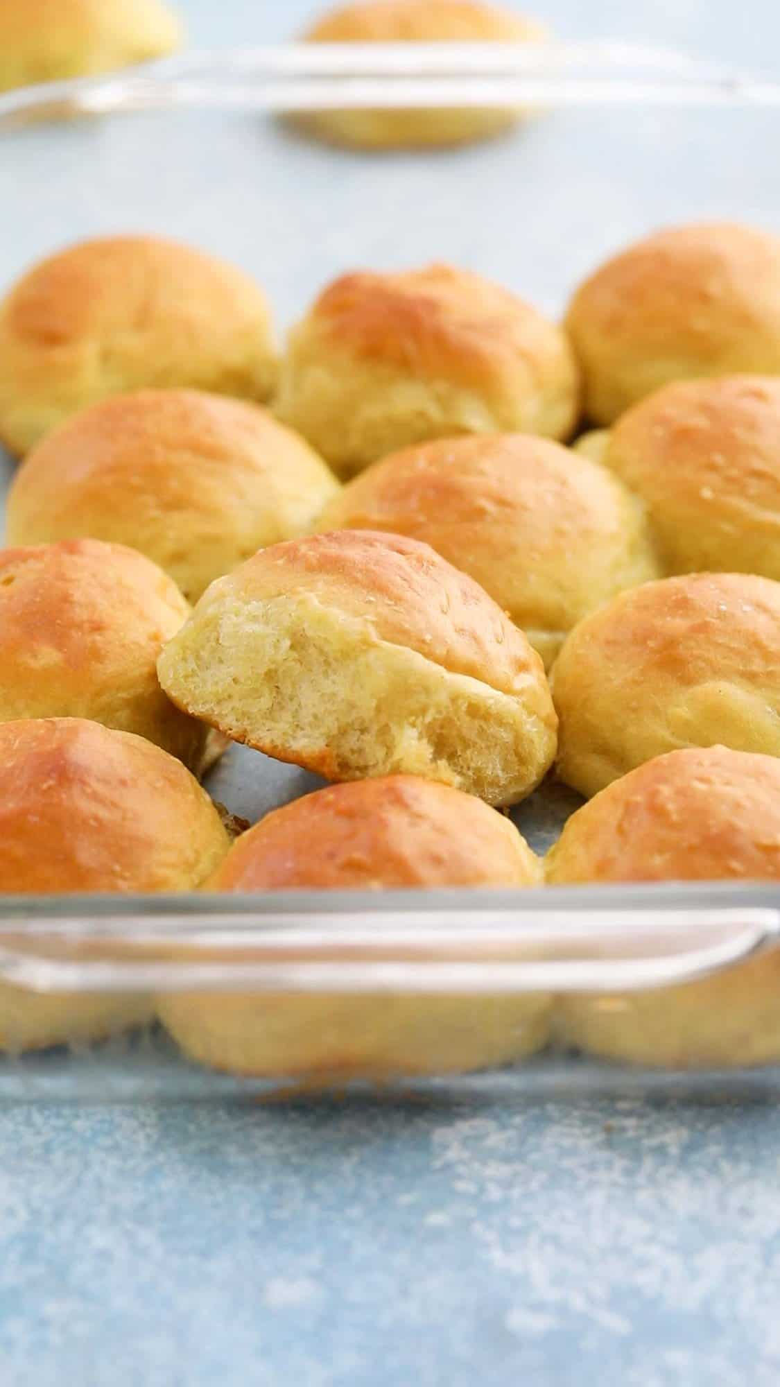 a glass baking dish with baked dinner rolls. 