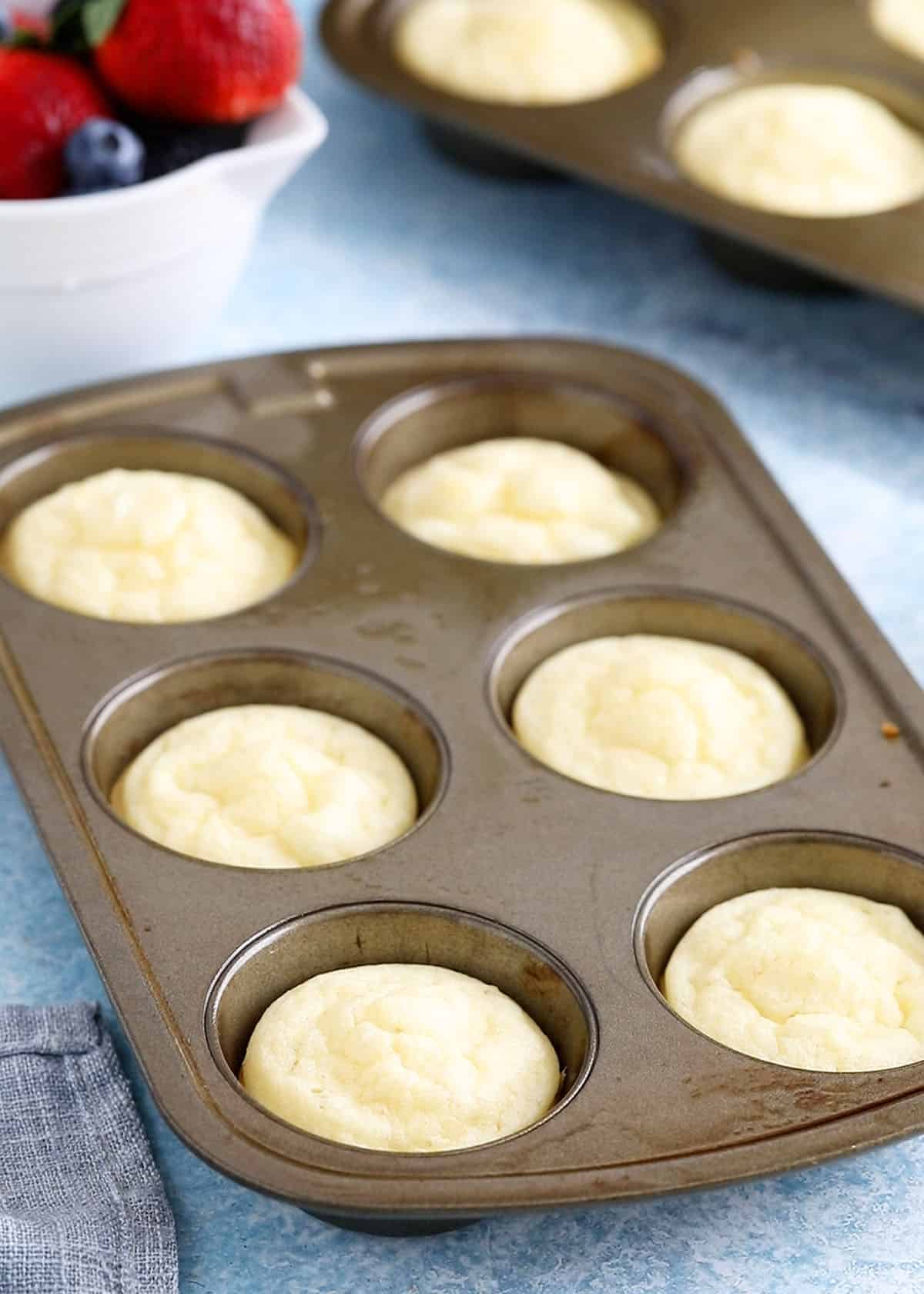 baked pancake muffins in a metal muffin pan.
