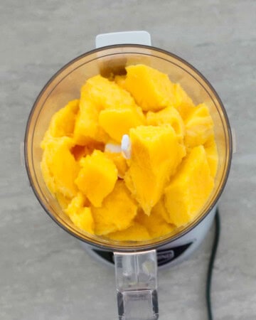 chopped mango pieces in a mini food processor.