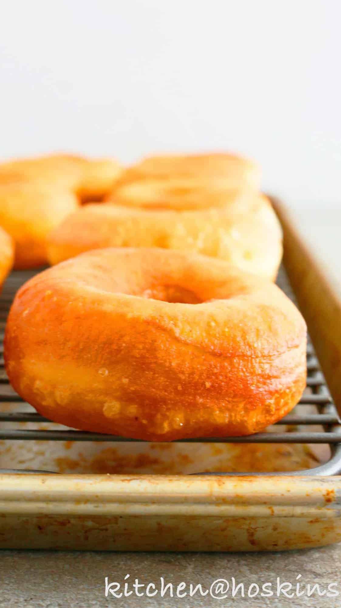 deep fried donuts on a wire rack.