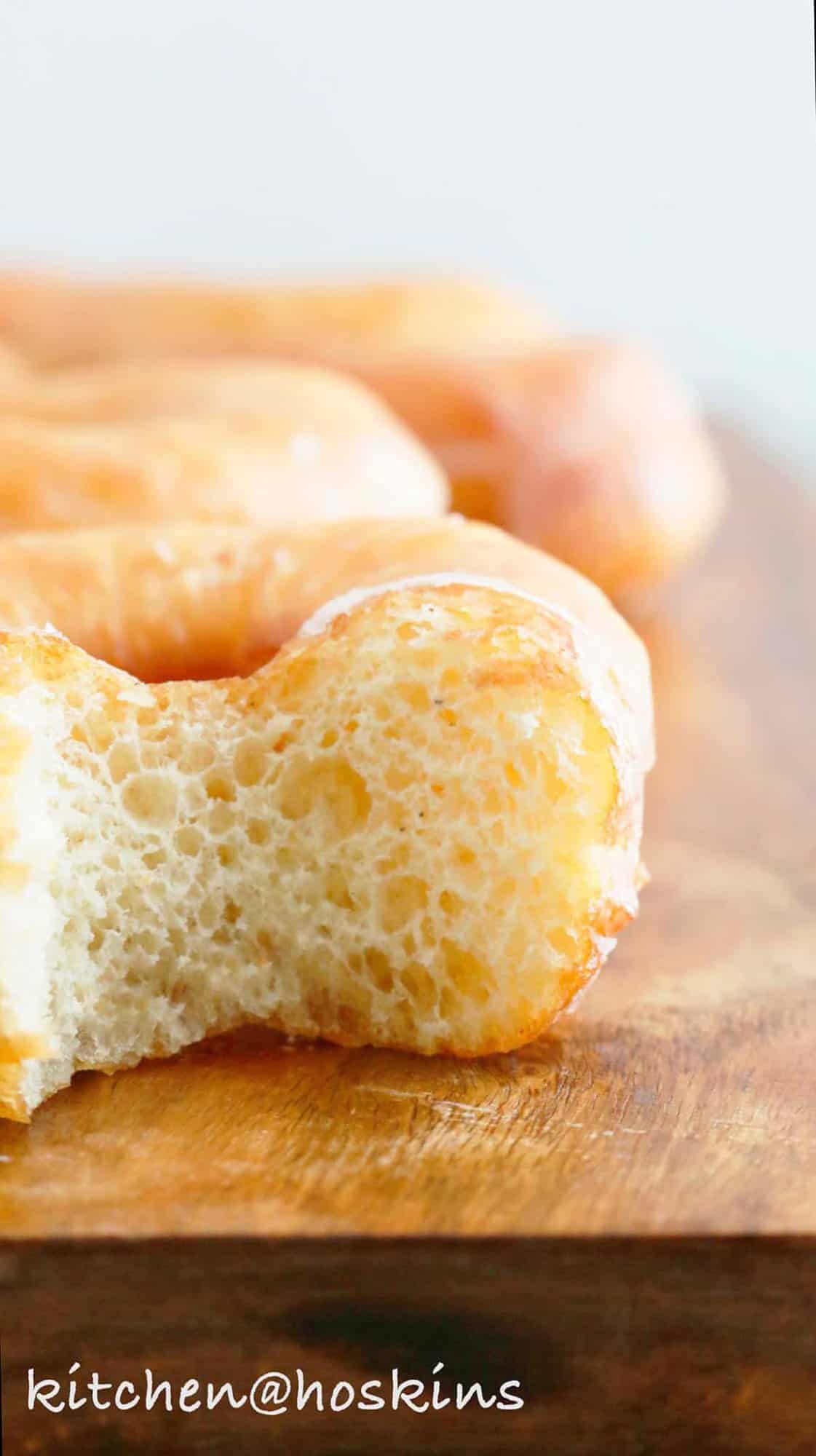 a close up shot of half bitten donut.