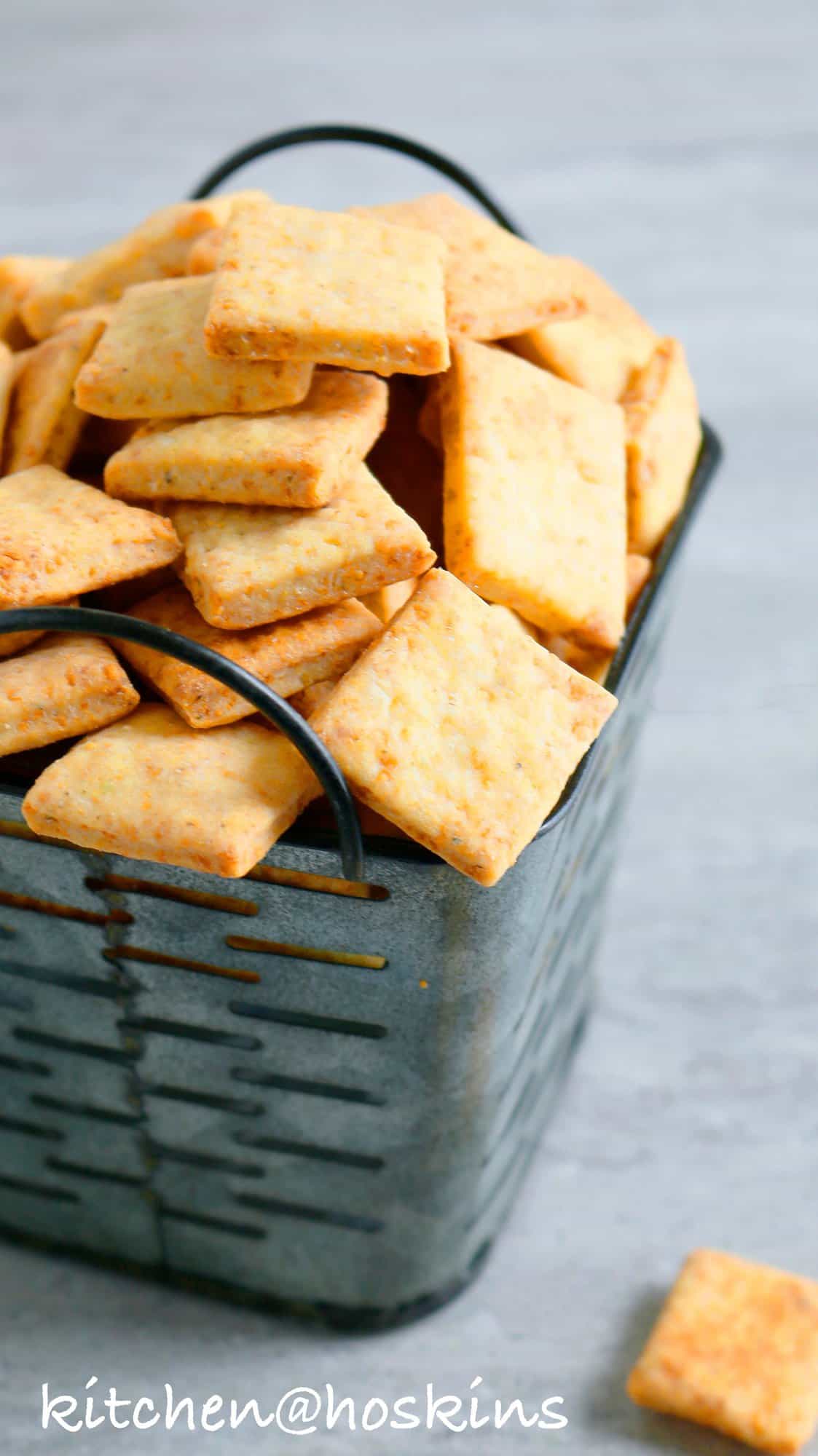 a metal basket with baked parmesan crackers. 