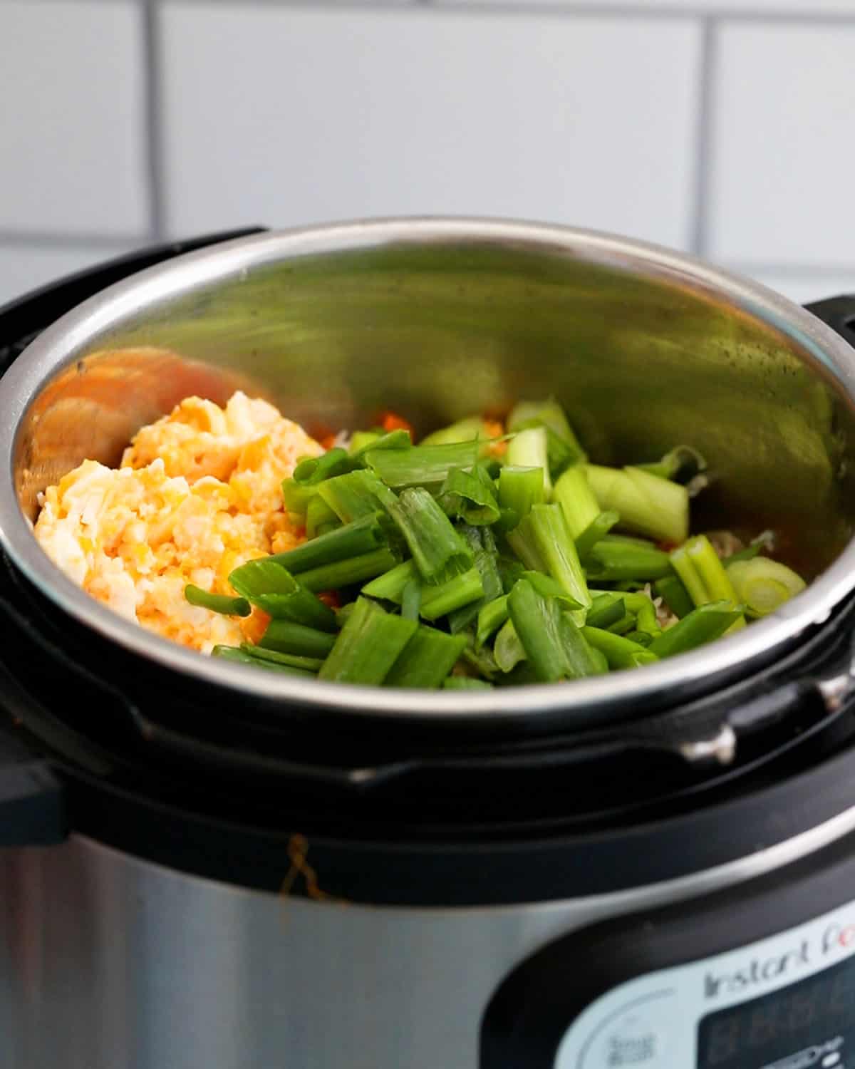 cooked yellow eggs and green scallions in an instant pot.