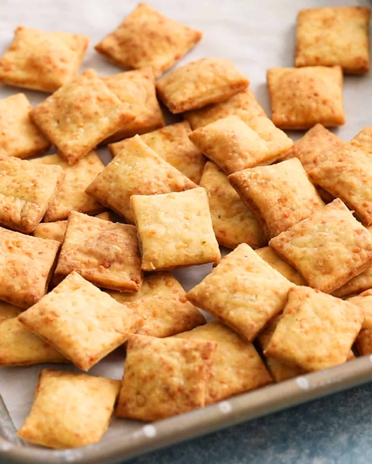 square crackers on a metal baking sheet.