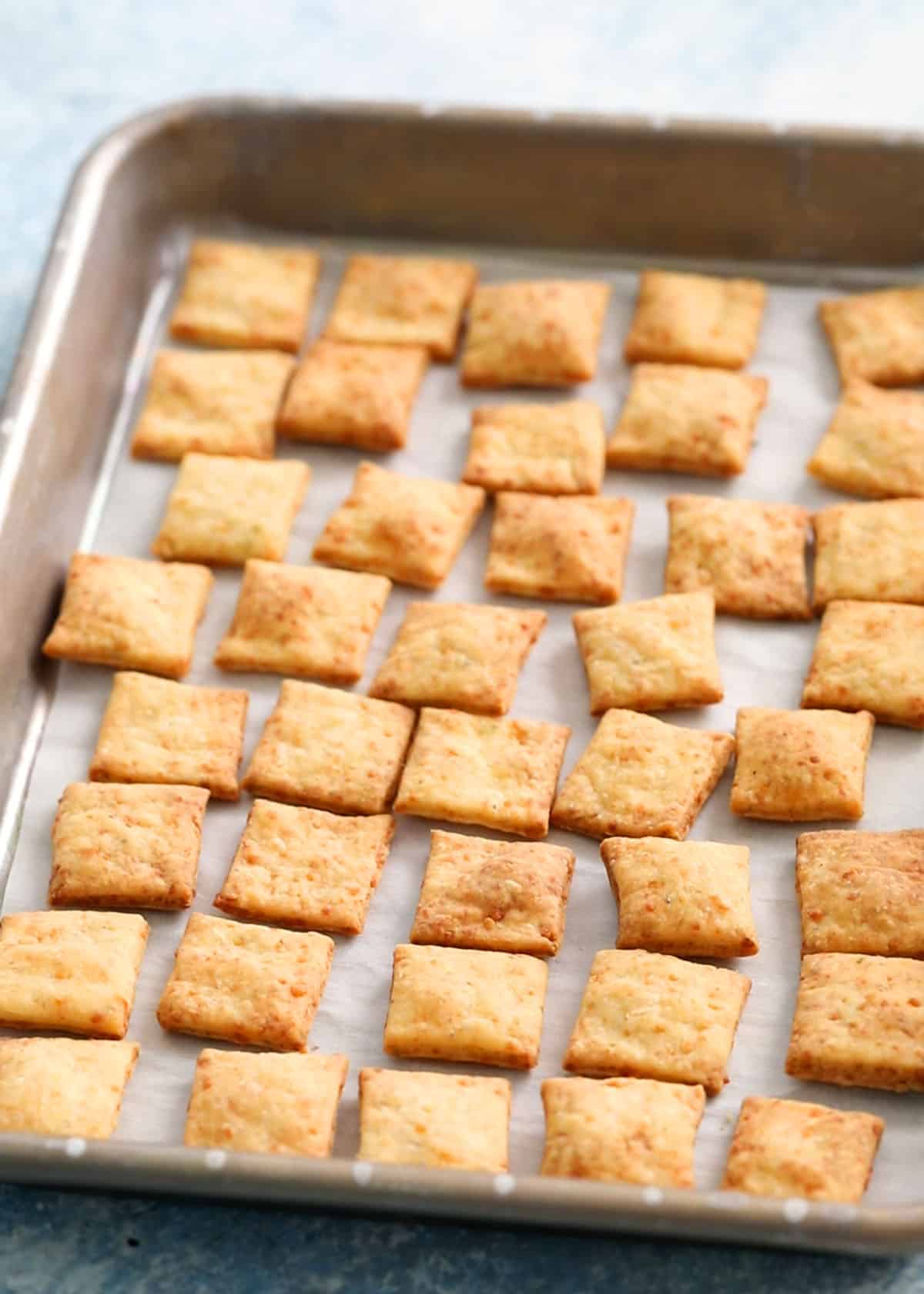 square crackers on a metal baking sheet.