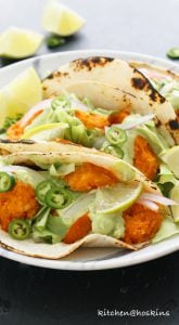 buffalo shrimp tacos with avocado jalapeno crema