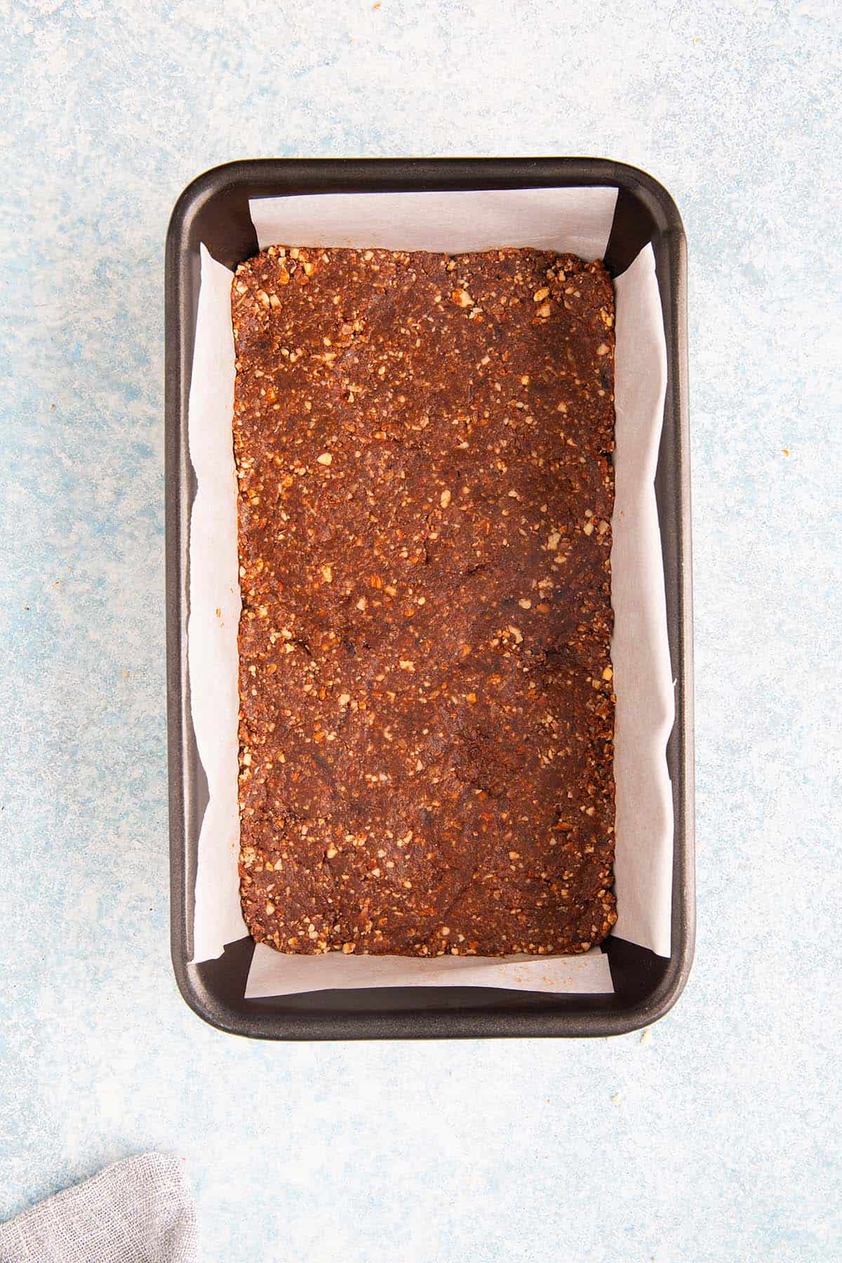 date and nut mixture in a loaf pan before cutting.
