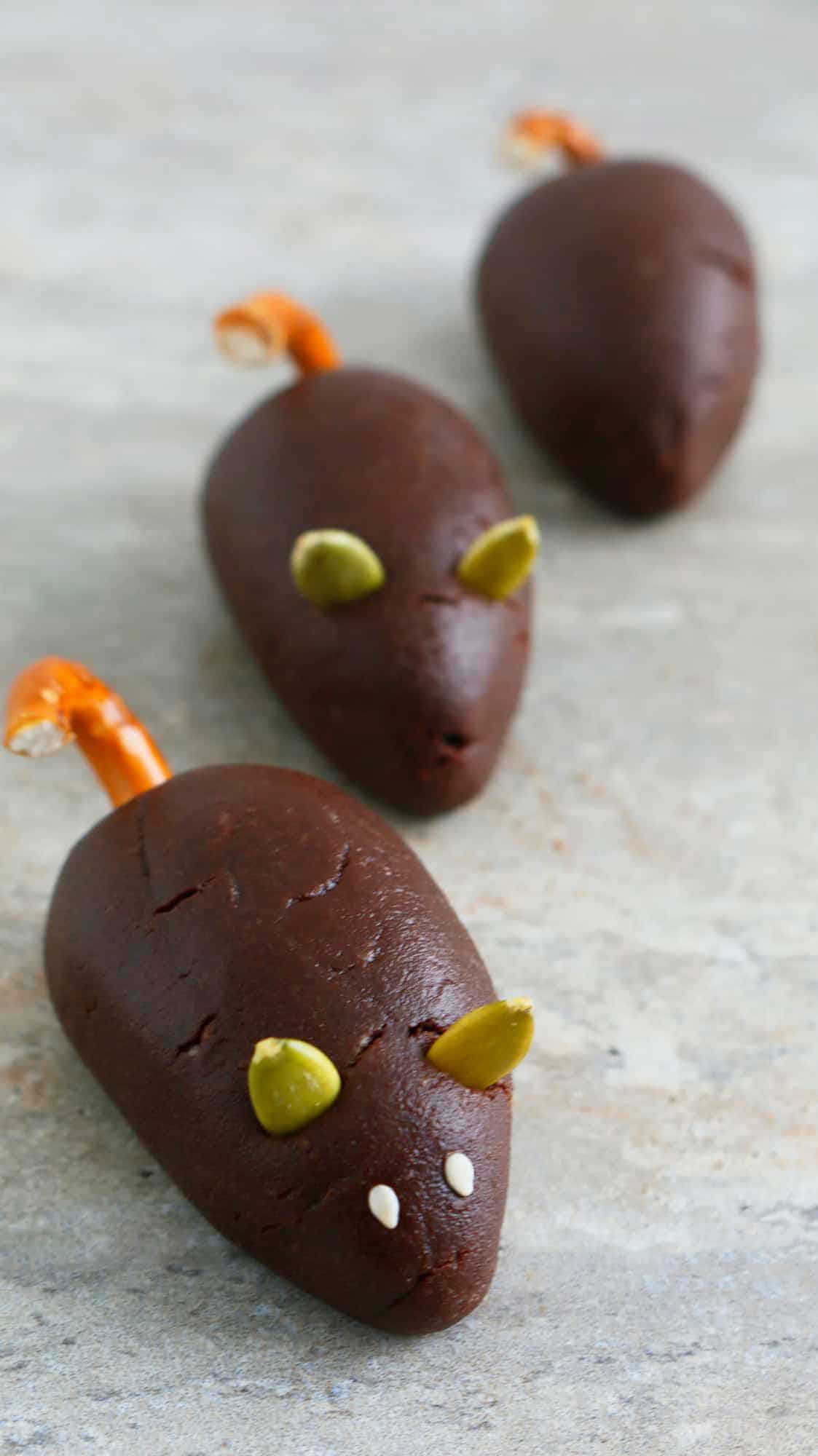 3 shaped chocolate mice on a grey board.