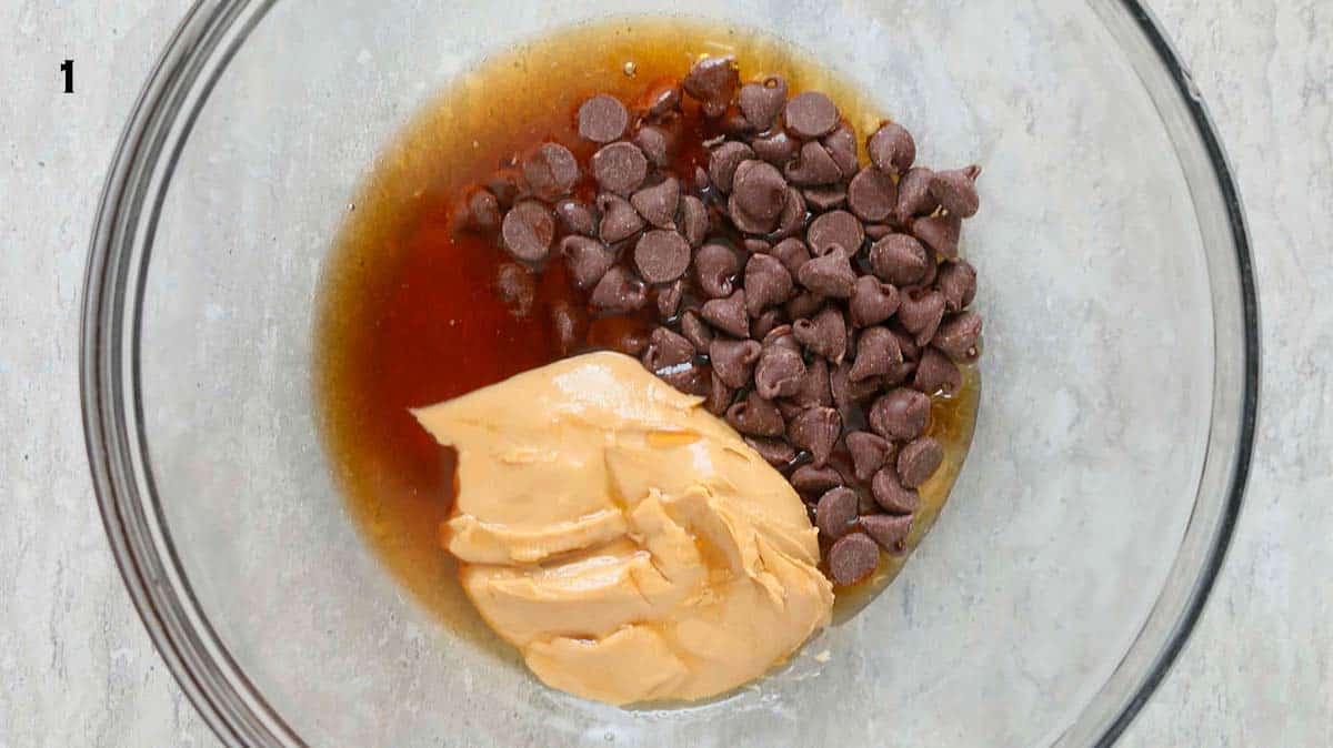 almond butter, chocolate chips and maple syrup in a glass bowl.