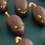 three chocolate mice on a black board.