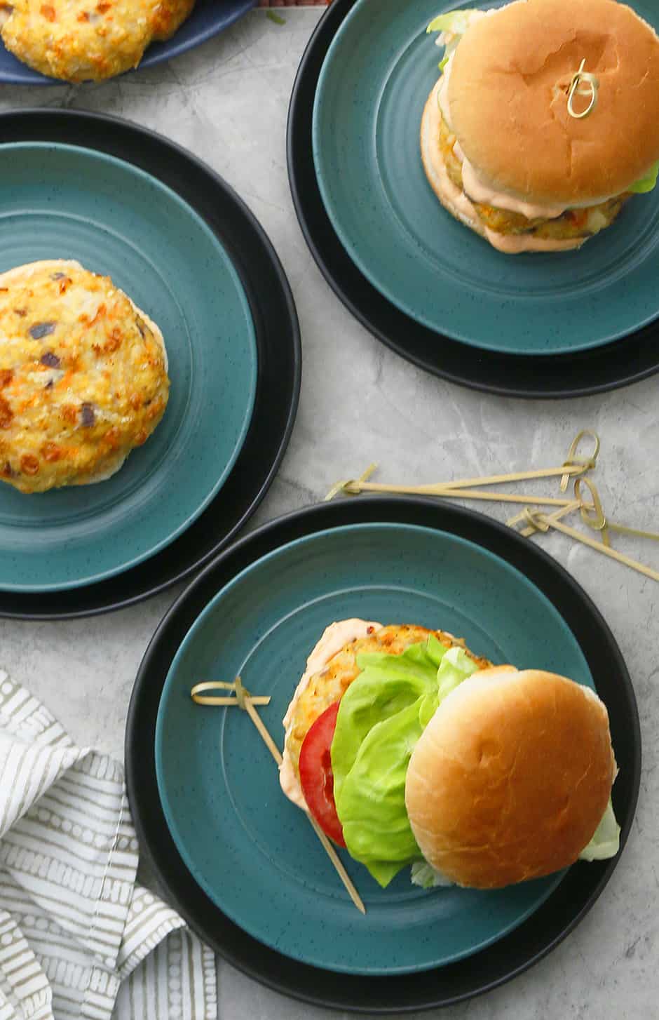 oven baked chicken burgers on green plates 