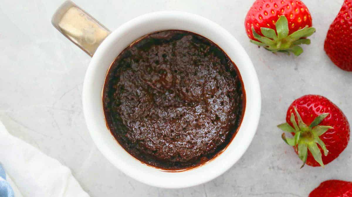 one white mug with cooked chocolate cake.