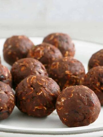 no bake chocolate oatmeal balls on a white plate.