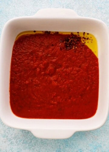red sauce in a white baking dish.