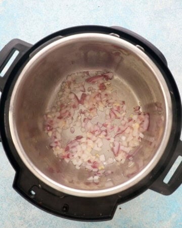 chopped onion cooking in an instant pot.
