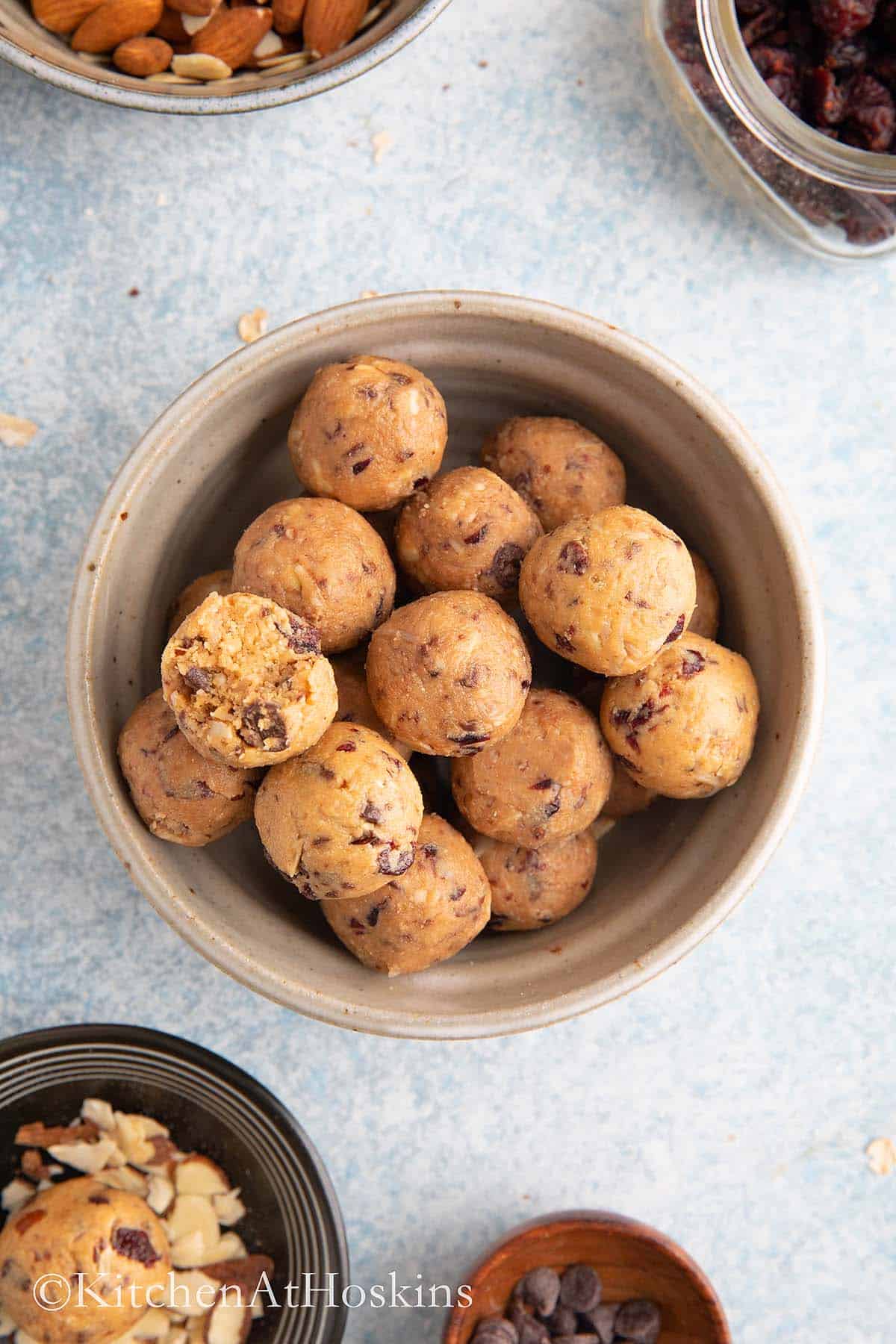 a grey ceramic bowl filled with raw almond balls.