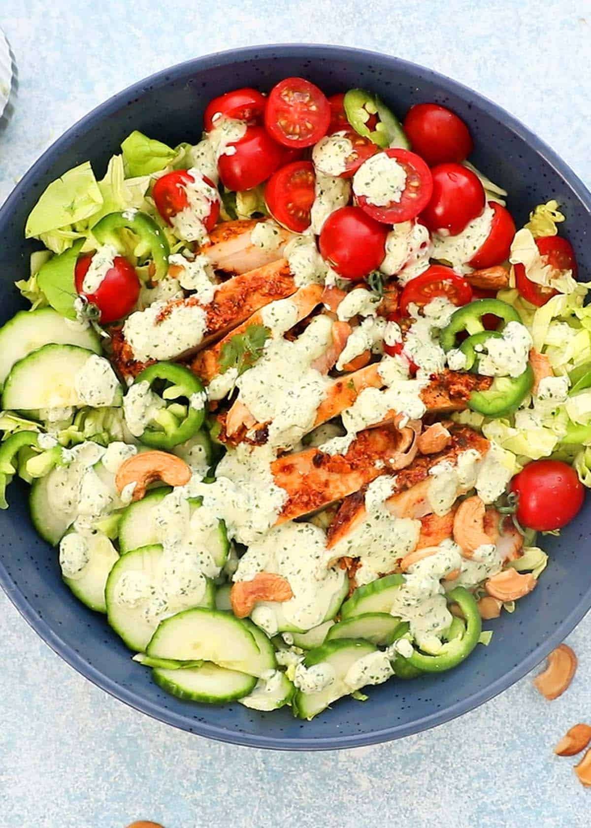 assembled chicken salad in a large blue bowl.
