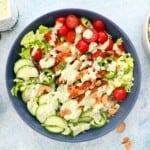 assembled chicken salad in a large blue bowl.