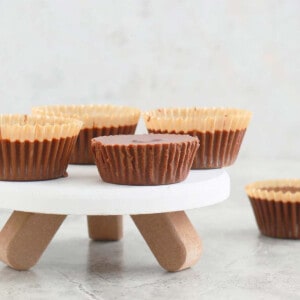 4 almond butter cups placed in a white cake stand.