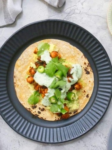 charred corn tortilla with Mexican chickpeas, cilantro sauce, avocado, lettuce and jalapenos