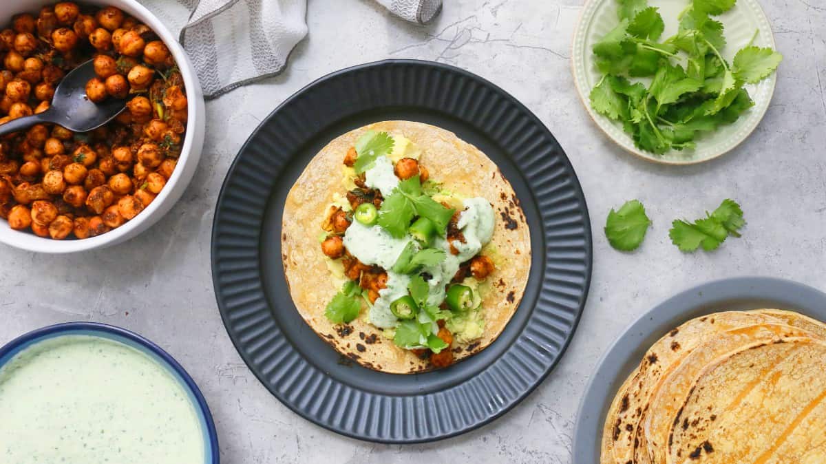 charred corn tortilla with Mexican chickpeas, cilantro sauce, avocado, lettuce and jalapenos